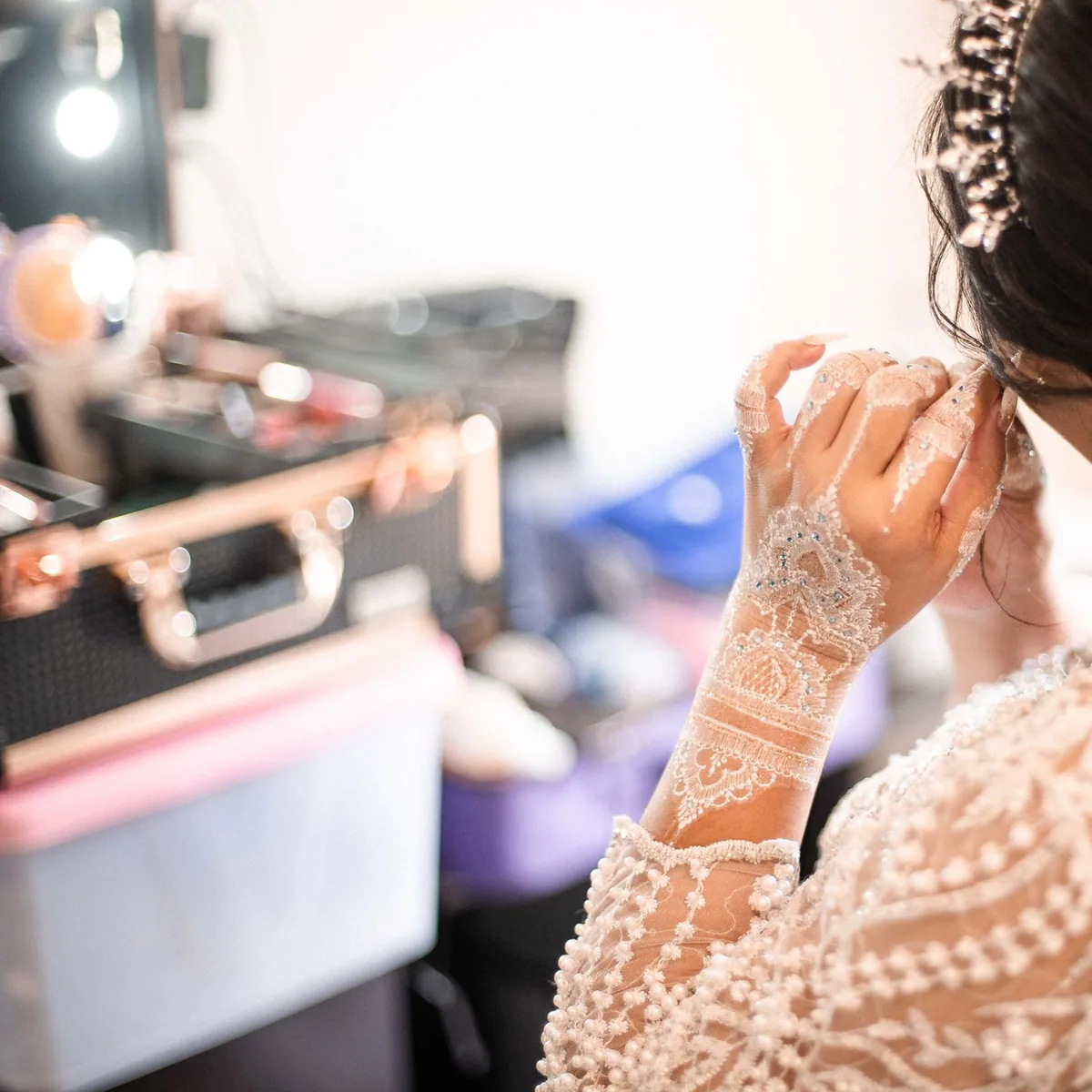 Professional makeup brushes, palettes and airbrush equipment laid out at the studio