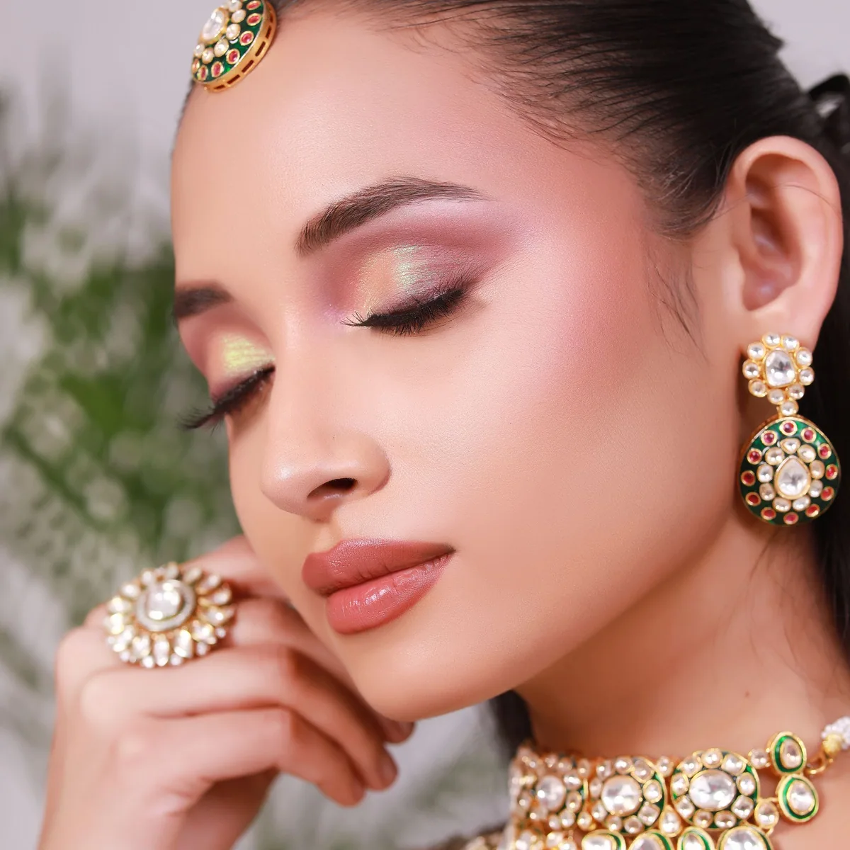 Close crop of reception eye makeup showing shimmer shadow, winged liner and lash extensions