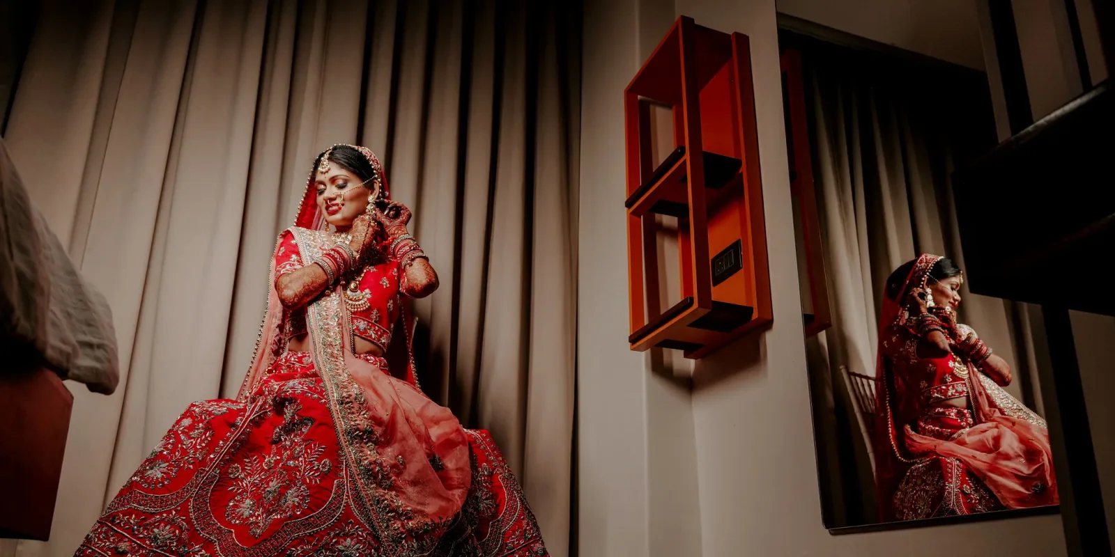 Bride in bridal dress being prepared before a wedding function